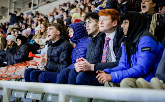 A crowd of students cheering on Team Newcastle